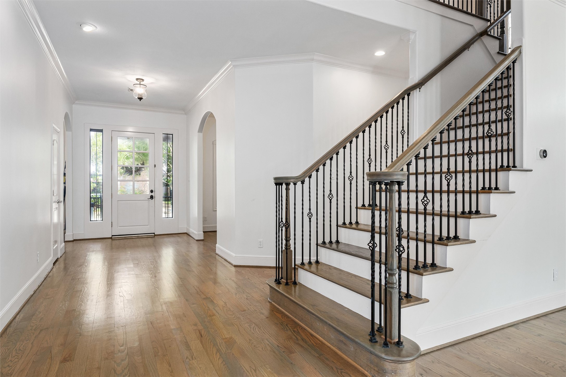 4523 Maple Street Bellaire, TX 77401 - Photo 5 of 50 An alternate view of the entryway highlights the front door framed by side windows that fill the space with natural light. The first floor has been beautifully updated with modern finishes and design details.