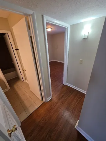 a view of a hallway with wooden floor
