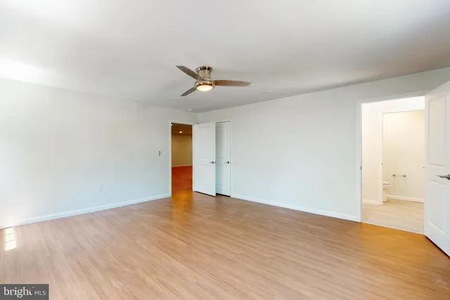 a view of an empty room with wooden floor
