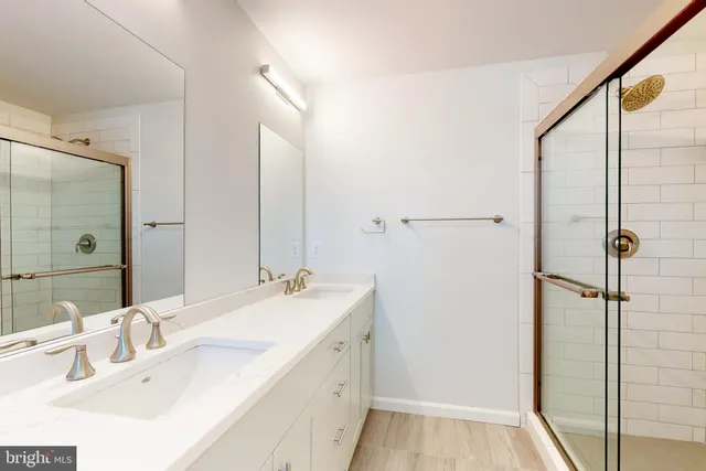 a bathroom with a double vanity sink mirror and double
