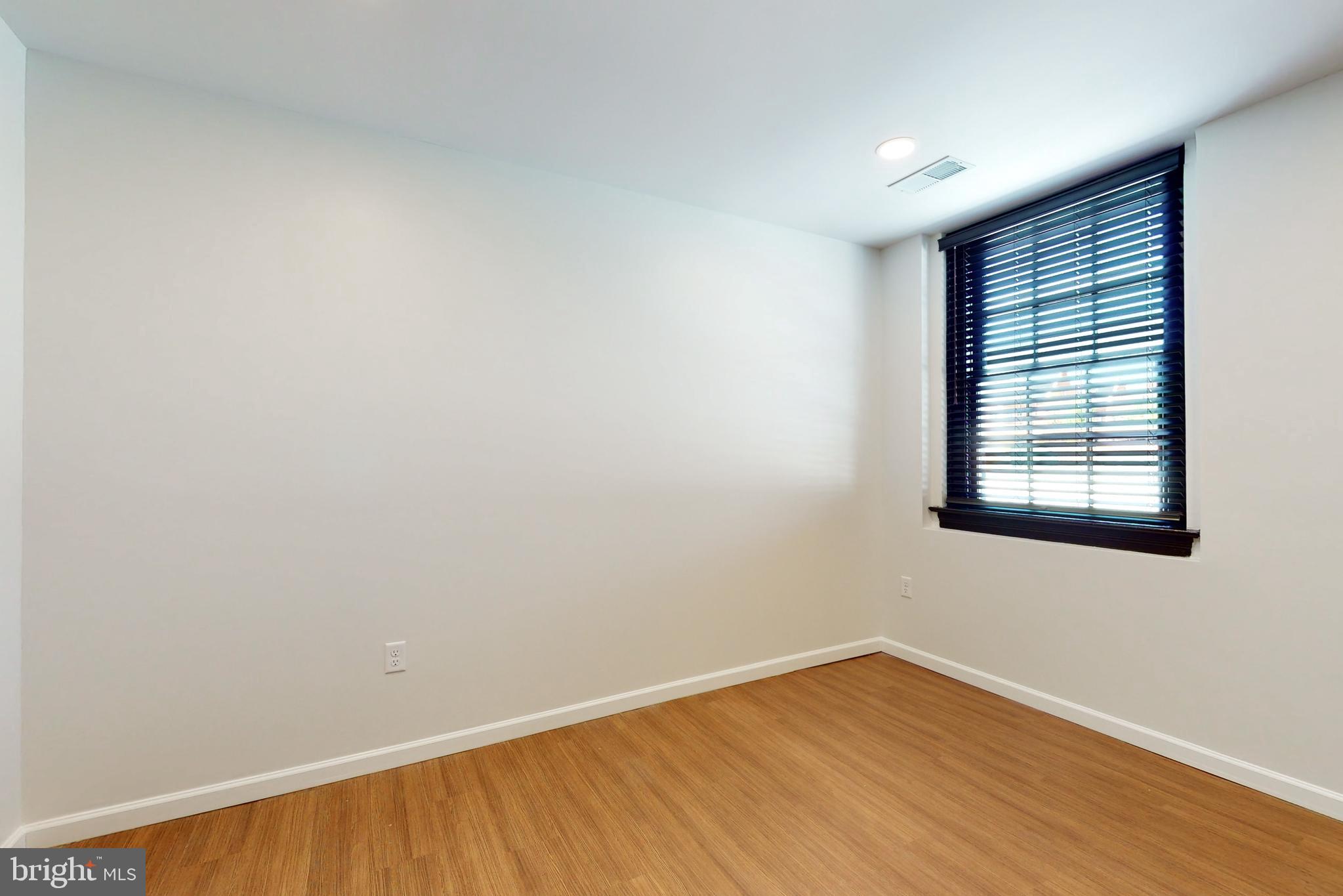 210 East Boscawen Street, Unit 204 Winchester, VA 22601 - Photo 20 of 20 wooden floor in an empty room with a window