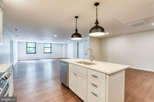 a view of a center island and wooden floor