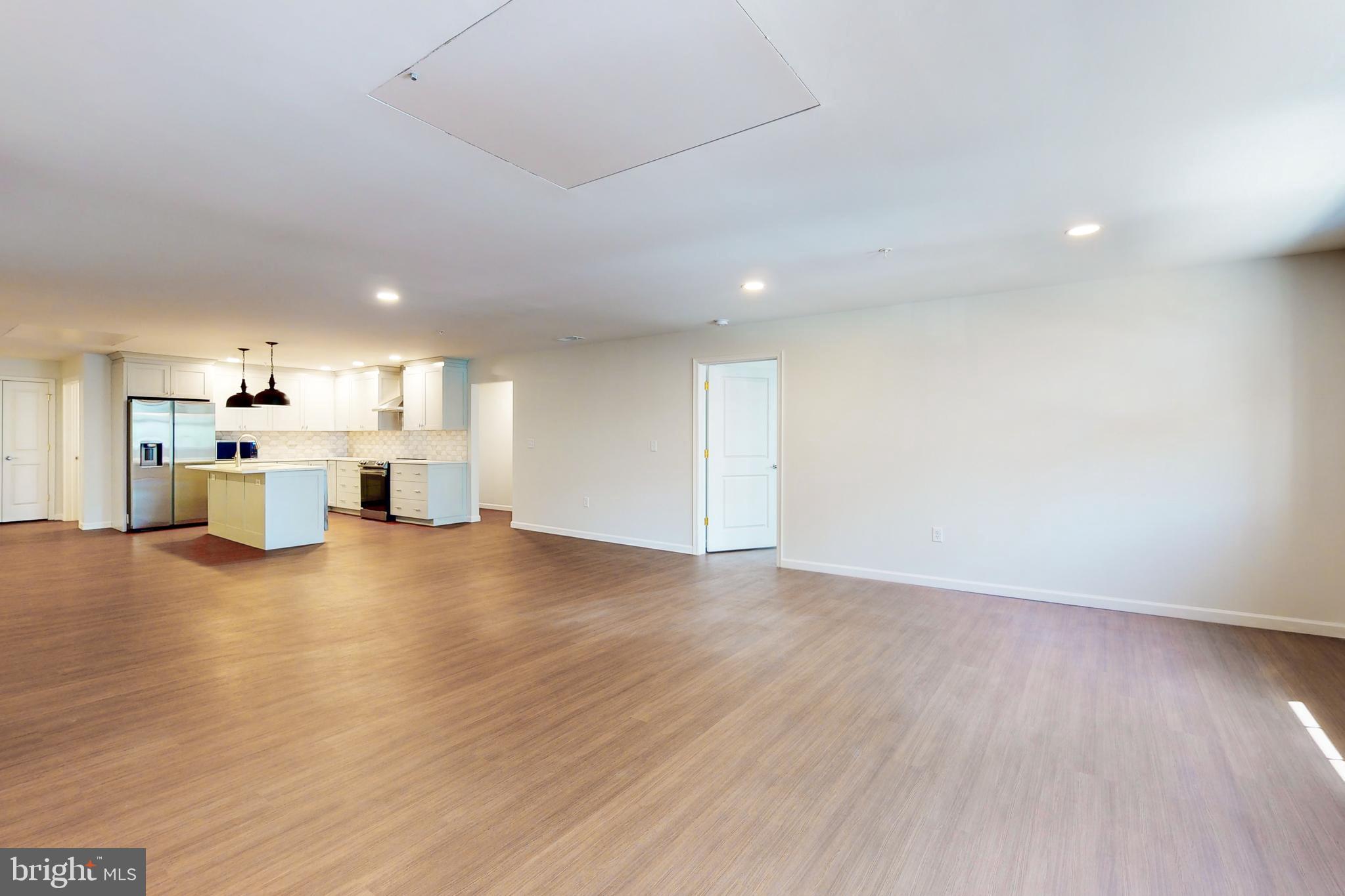 210 East Boscawen Street, Unit 204 Winchester, VA 22601 - Photo 8 of 20 a view of kitchen with furniture and wooden floor