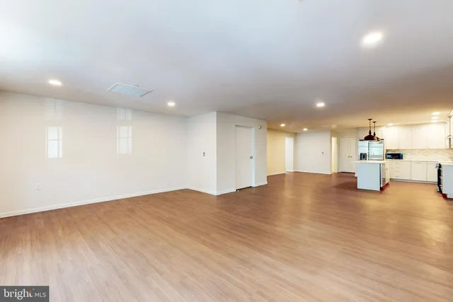 a view of empty room with wooden floor