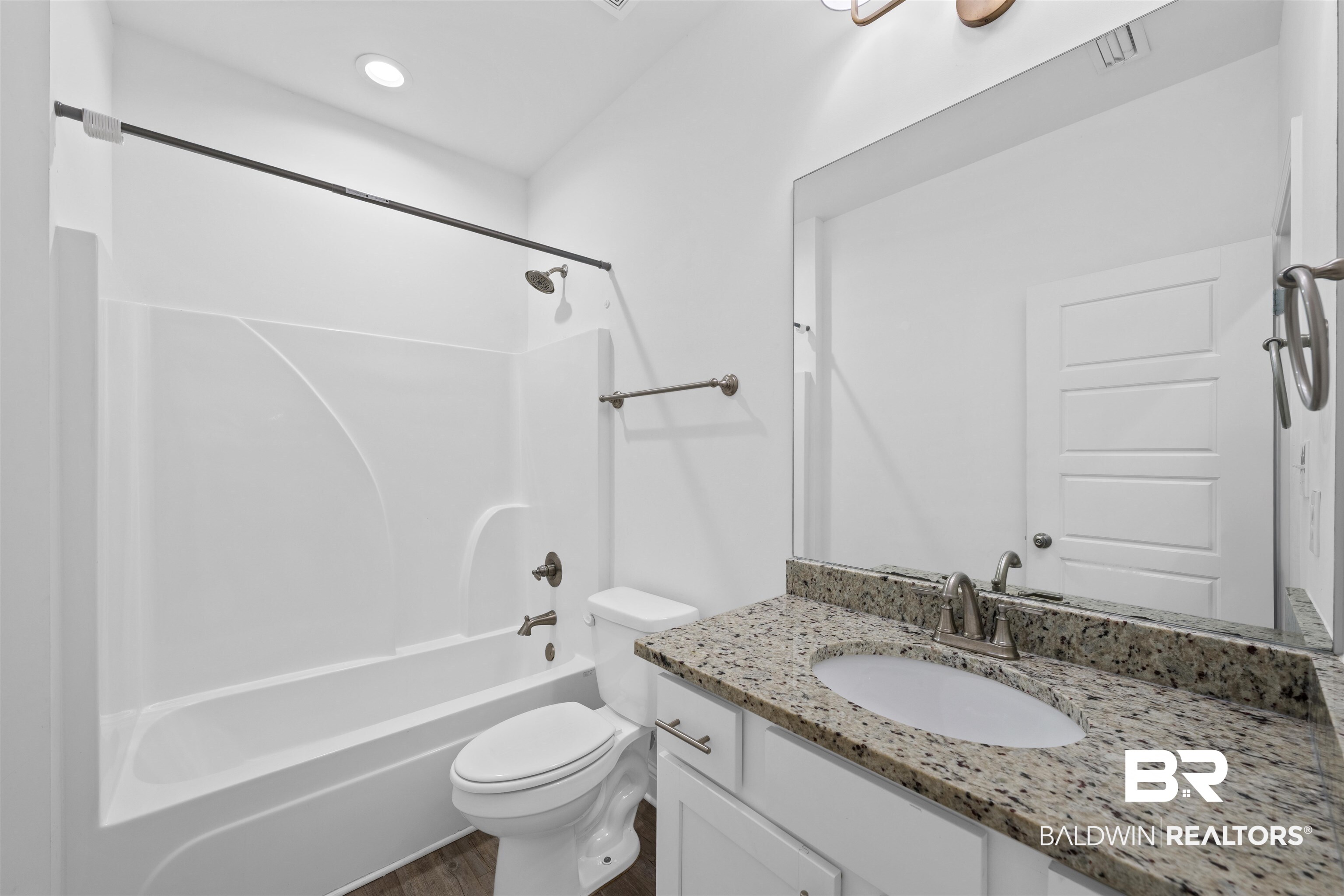 2651 South Juniper Street, Unit 1801 Foley, AL 36535 - Photo 9 of 16 Bathroom featuring a white tub and shower combination, a toilet, and a vanity with a granite countertop