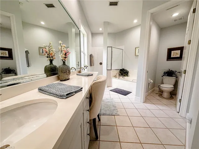 a kitchen with a sink and chairs