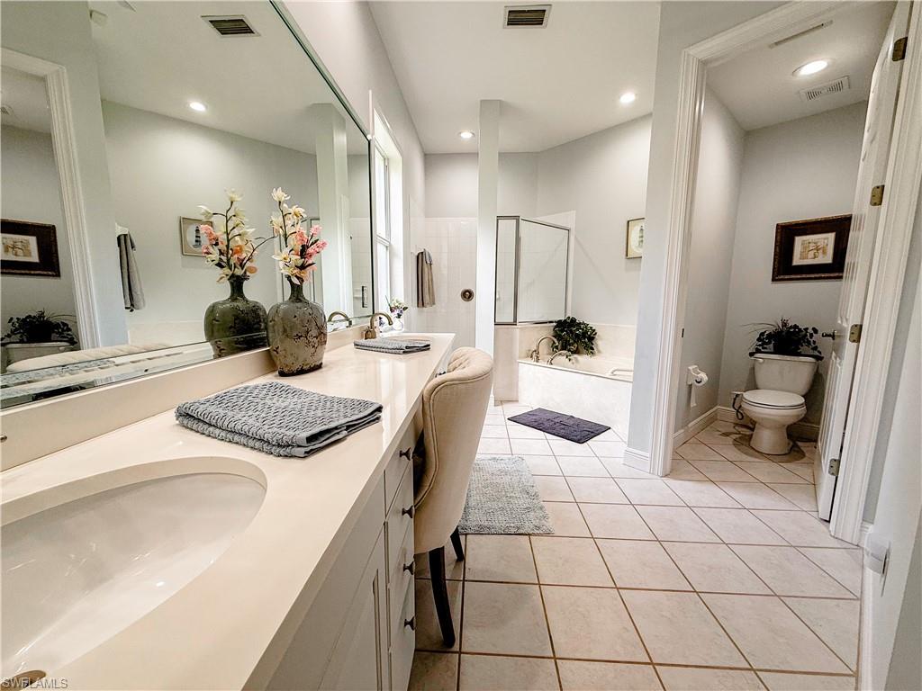 516 Eagle Creek Drive Naples, FL 34113 - Photo 16 of 28 a kitchen with a sink and chairs