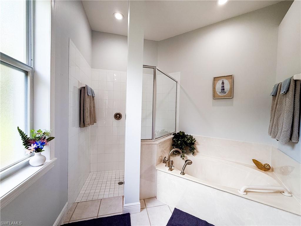 516 Eagle Creek Drive Naples, FL 34113 - Photo 17 of 28 a white bath tub sitting next to a white sink