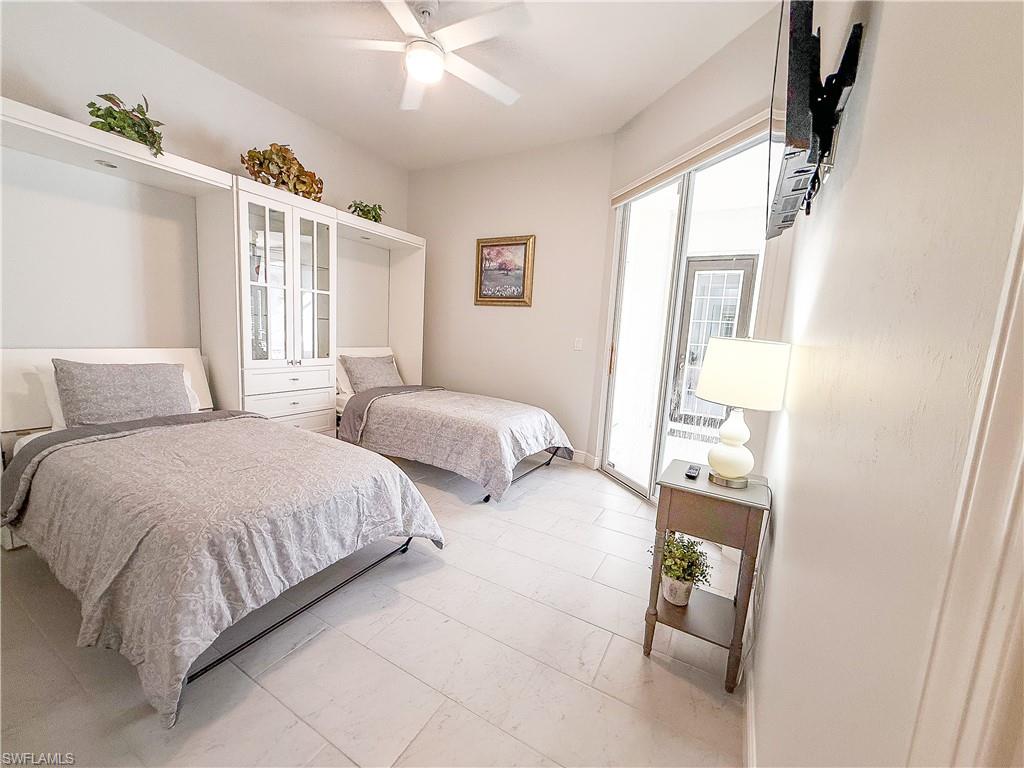 516 Eagle Creek Drive Naples, FL 34113 - Photo 20 of 28 a bedroom with two beds and a window