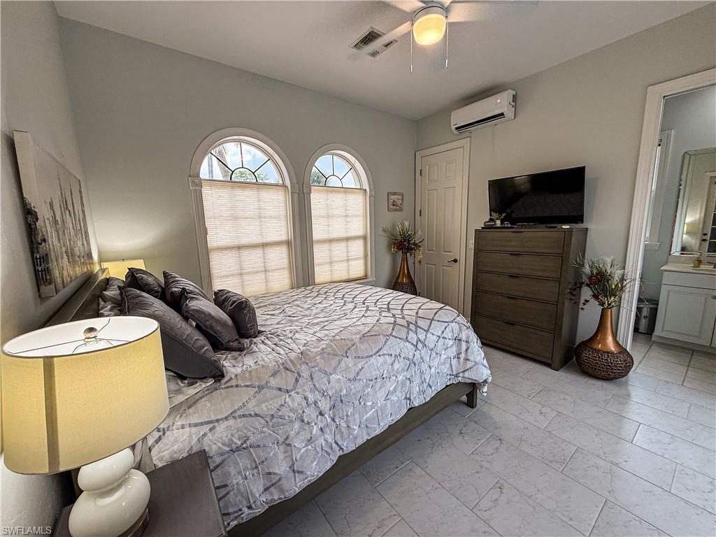 516 Eagle Creek Drive Naples, FL 34113 - Photo 23 of 28 a bedroom with a bed and a television