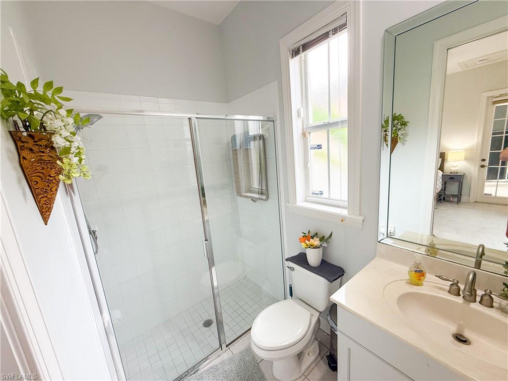 516 Eagle Creek Drive Naples, FL 34113 - Photo 25 of 28 a bathroom with a sink toilet and shower