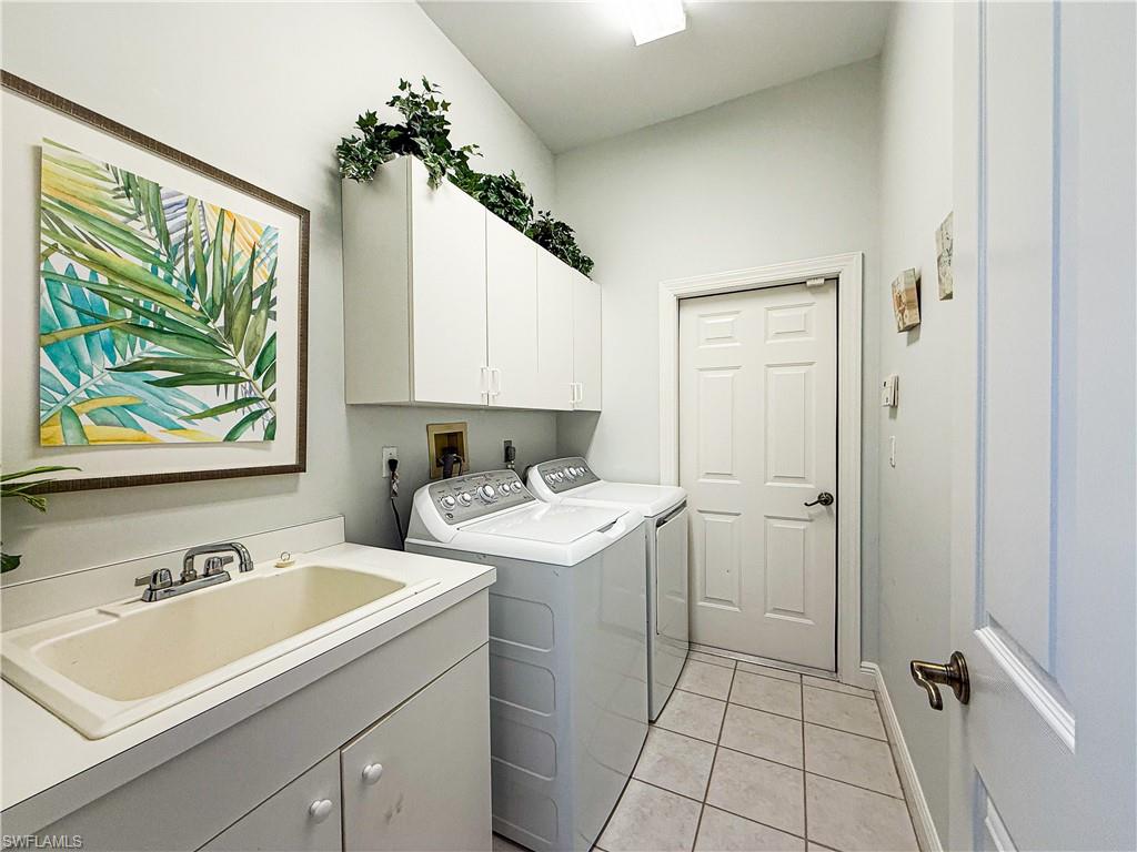 516 Eagle Creek Drive Naples, FL 34113 - Photo 26 of 28 a view of bathroom with a sink mirror and window