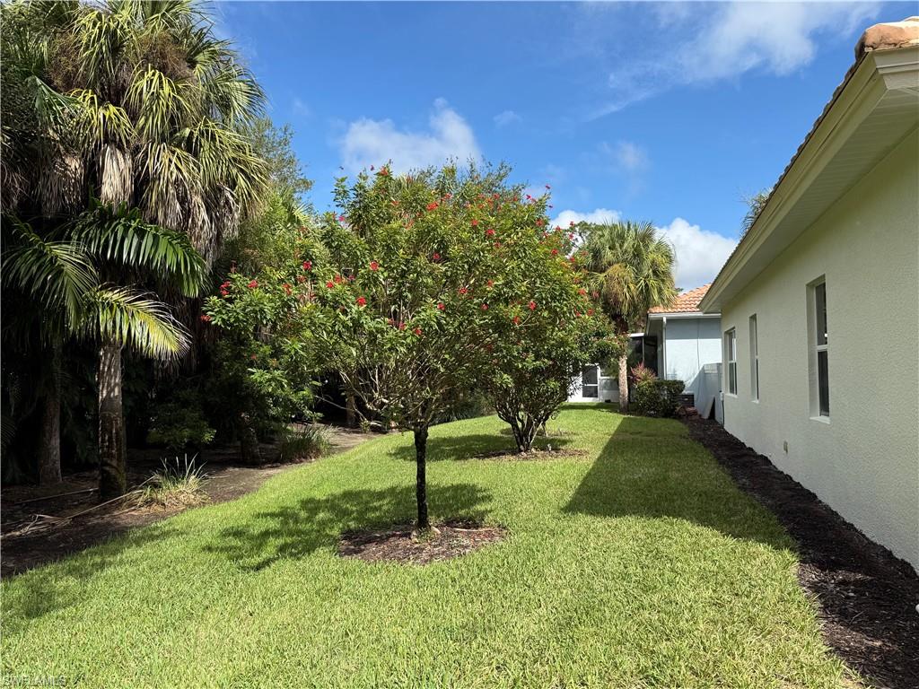 516 Eagle Creek Drive Naples, FL 34113 - Photo 28 of 28 a backyard of a house with lots of green space