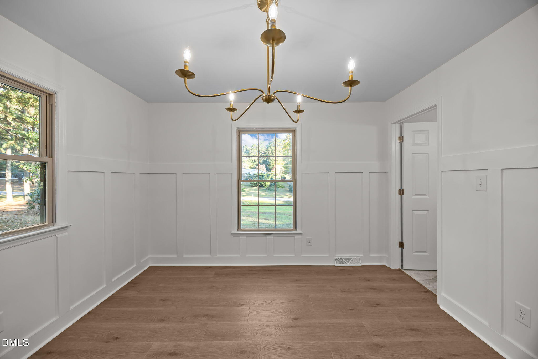 102 Royall Road Oxford, NC 27565 - Photo 14 of 53 a view of a room with a chandelier fan and wooden floor