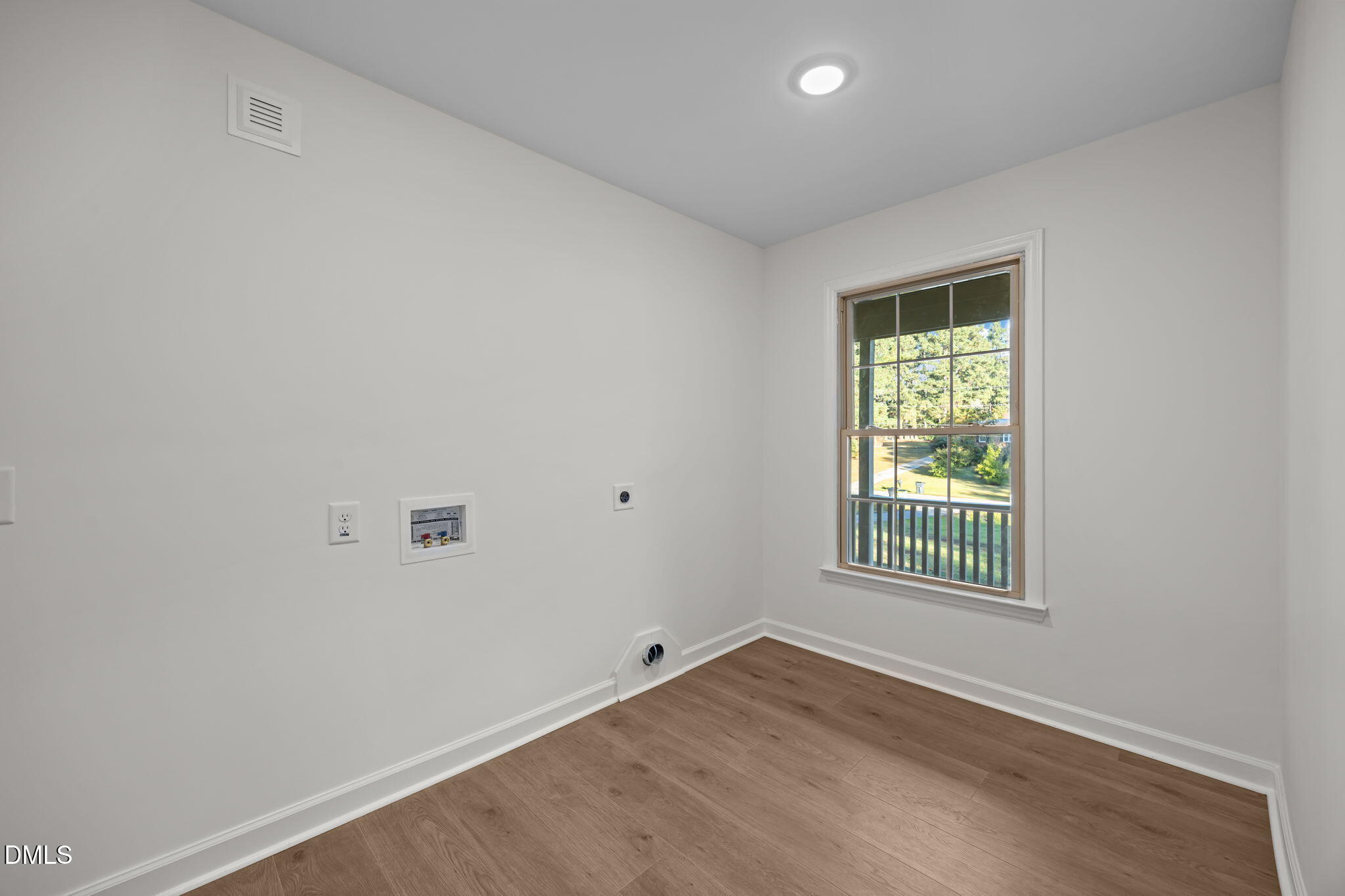 102 Royall Road Oxford, NC 27565 - Photo 19 of 53 an empty room with wooden floor and windows