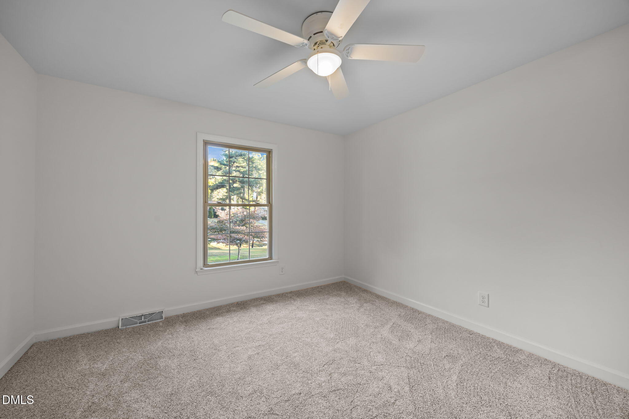 102 Royall Road Oxford, NC 27565 - Photo 33 of 53 an empty room with a window and a fan