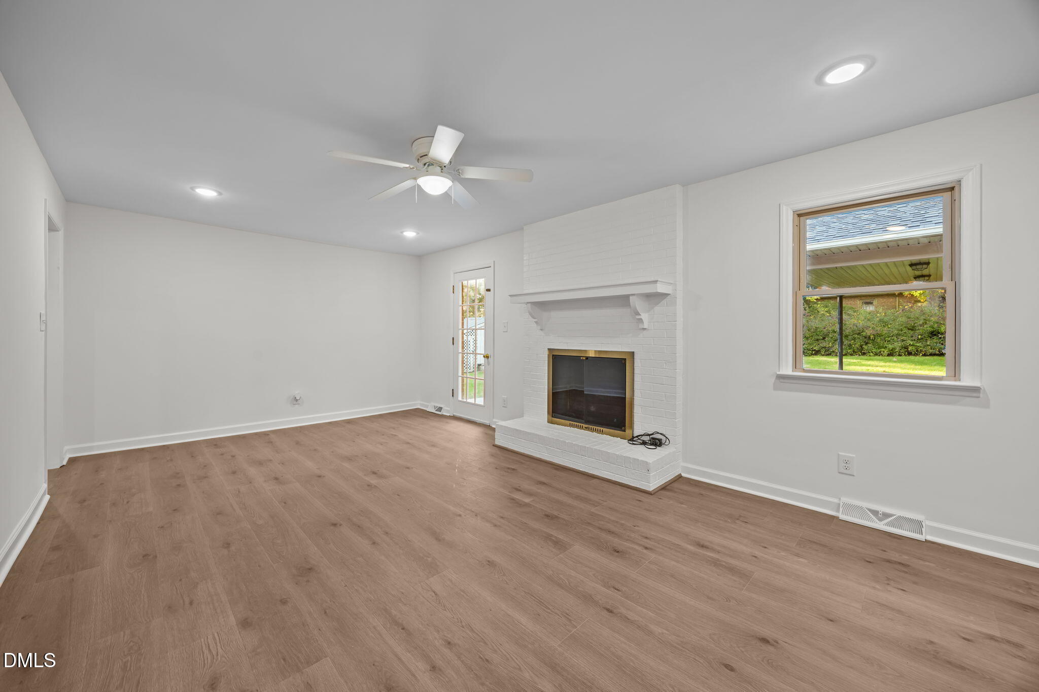 102 Royall Road Oxford, NC 27565 - Photo 4 of 53 an empty room with windows and fireplace