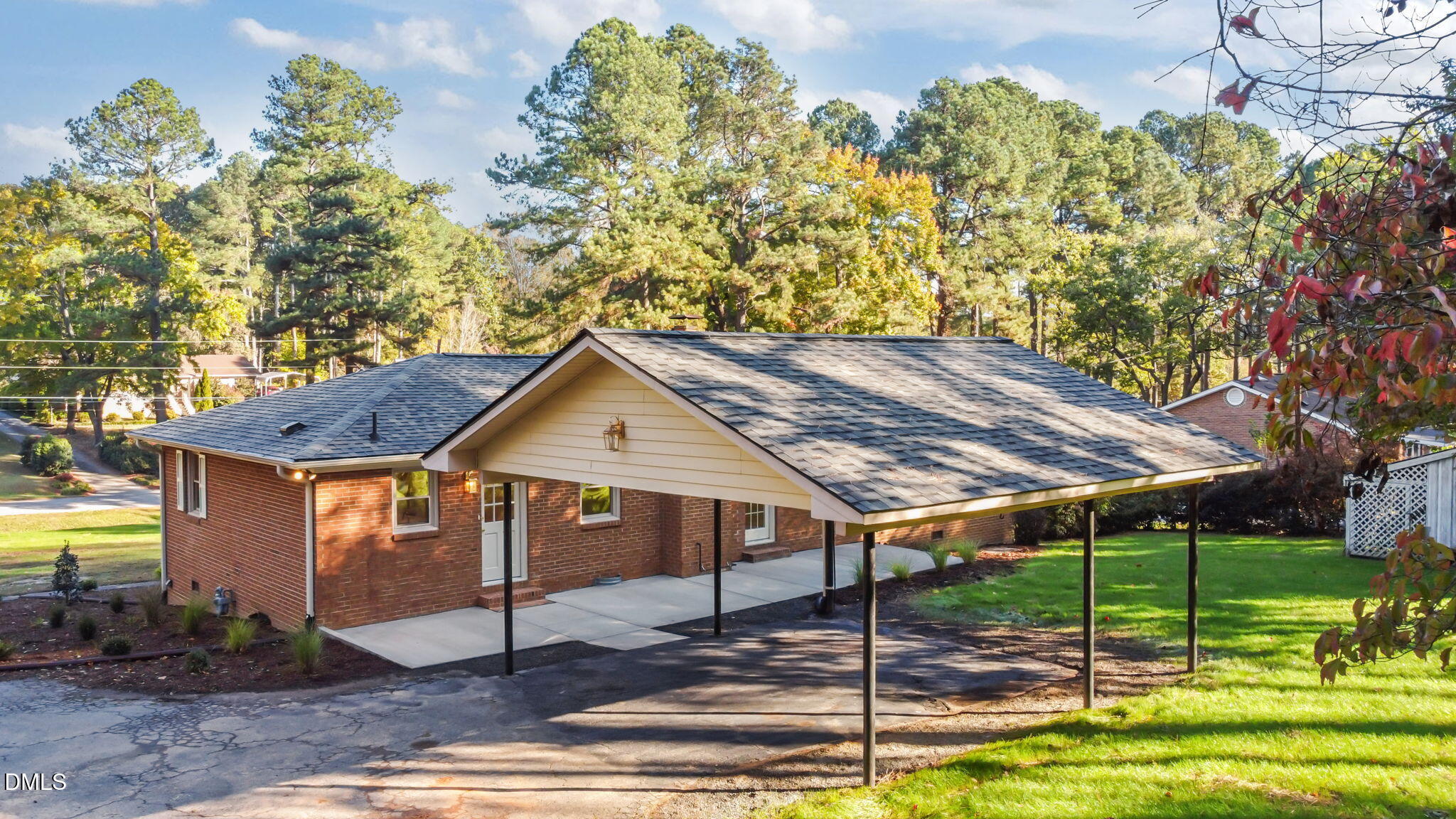 102 Royall Road Oxford, NC 27565 - Photo 41 of 53 a backyard of a house with table and chairs under an umbrella