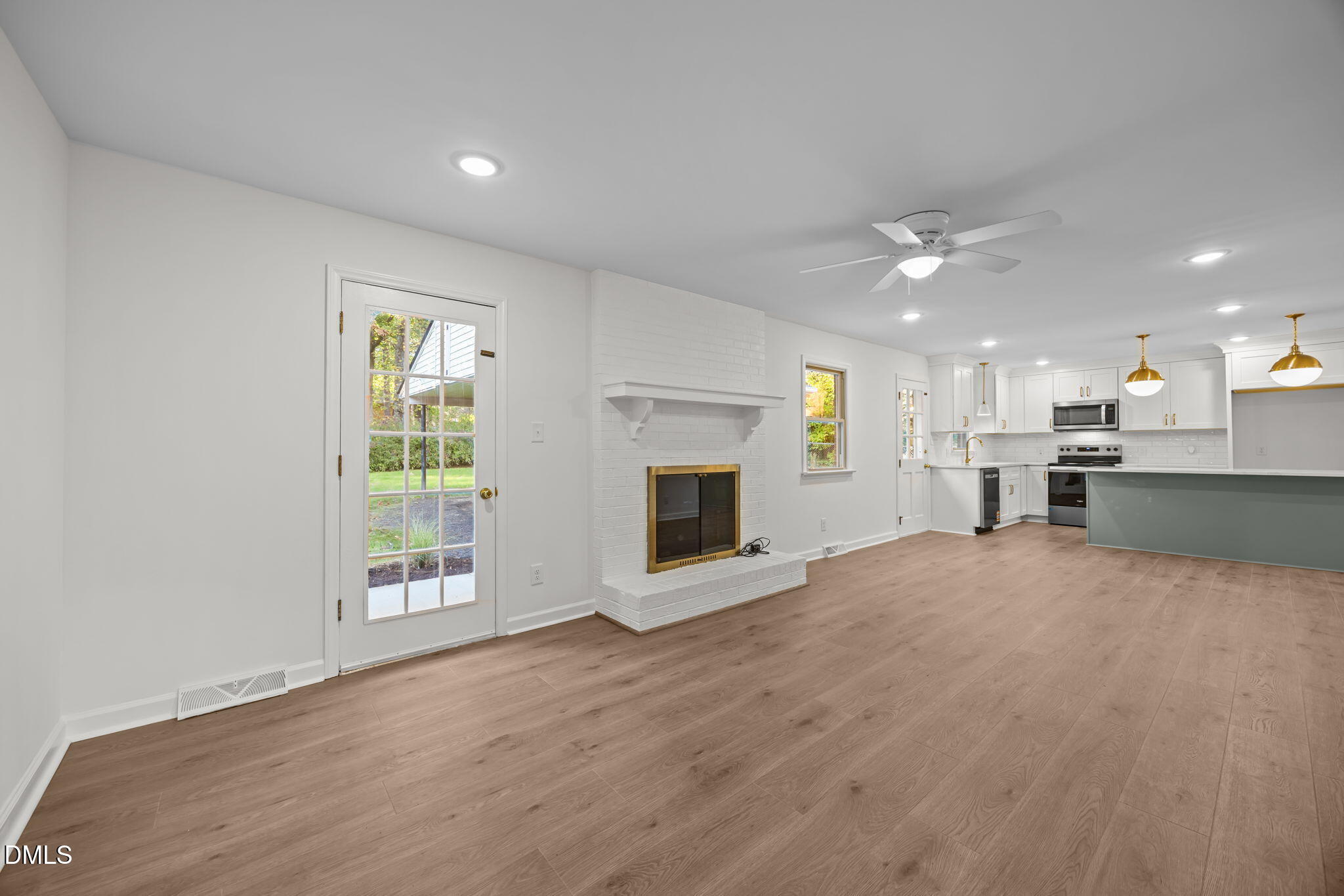102 Royall Road Oxford, NC 27565 - Photo 5 of 53 an empty room with windows and fireplace