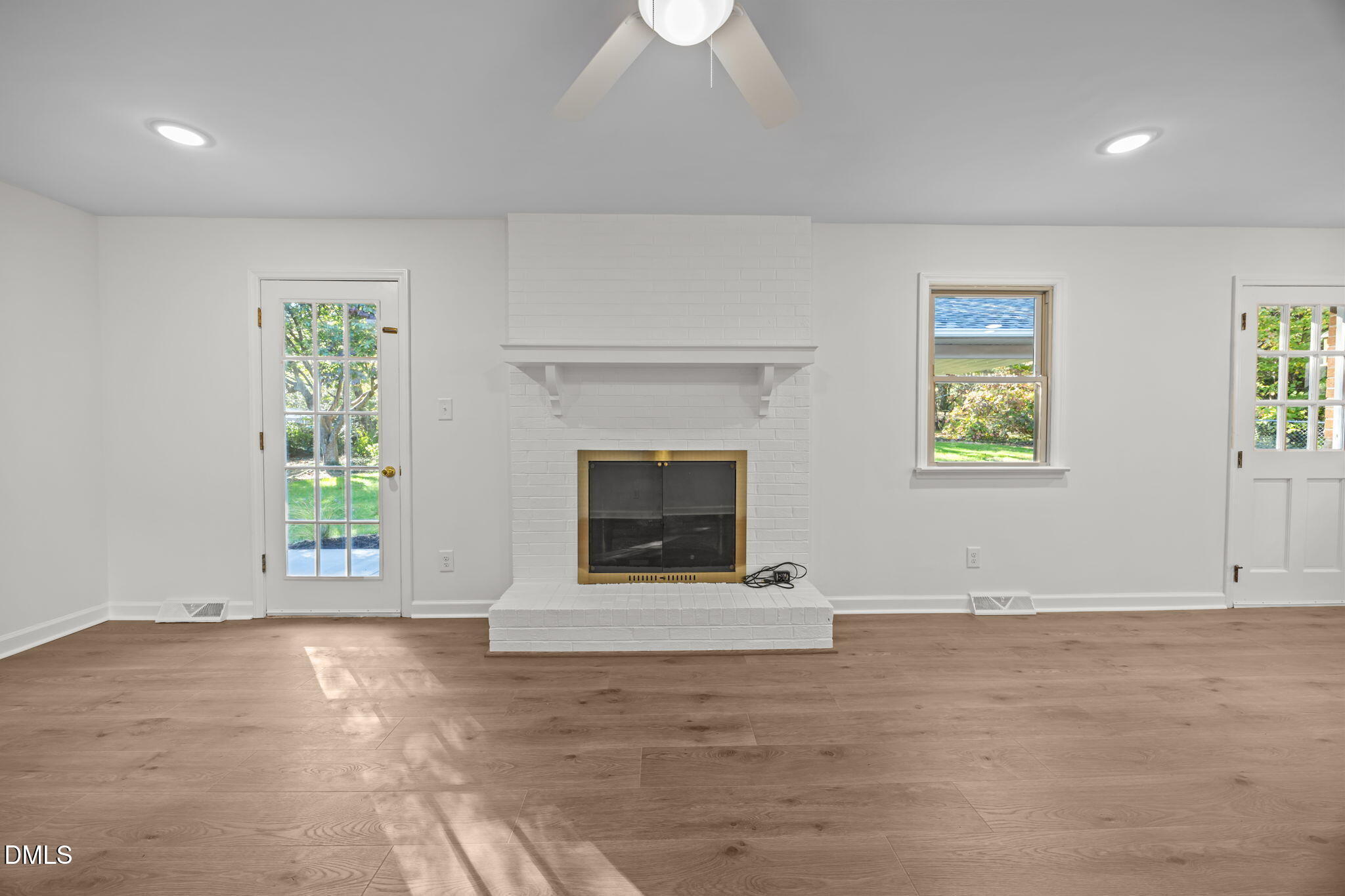 102 Royall Road Oxford, NC 27565 - Photo 6 of 53 an empty room with windows and fireplace