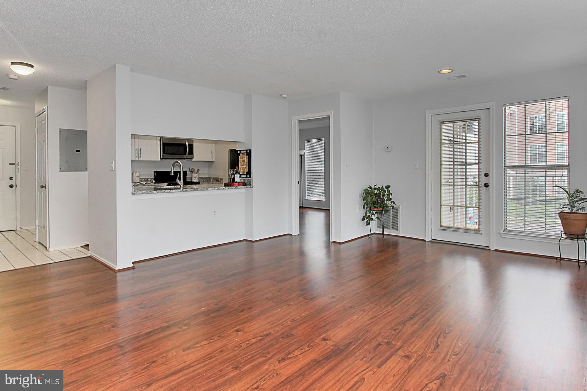 20950 Timber Ridge Terrace, Unit 201 Ashburn, VA 20147 - Photo 12 of 37 Living /Dining Room w/private deck