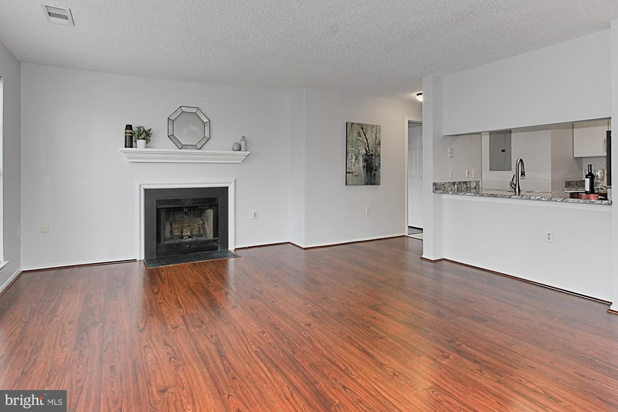 20950 Timber Ridge Terrace, Unit 201 Ashburn, VA 20147 - Photo 15 of 37 Living Room with Kitchen pass through