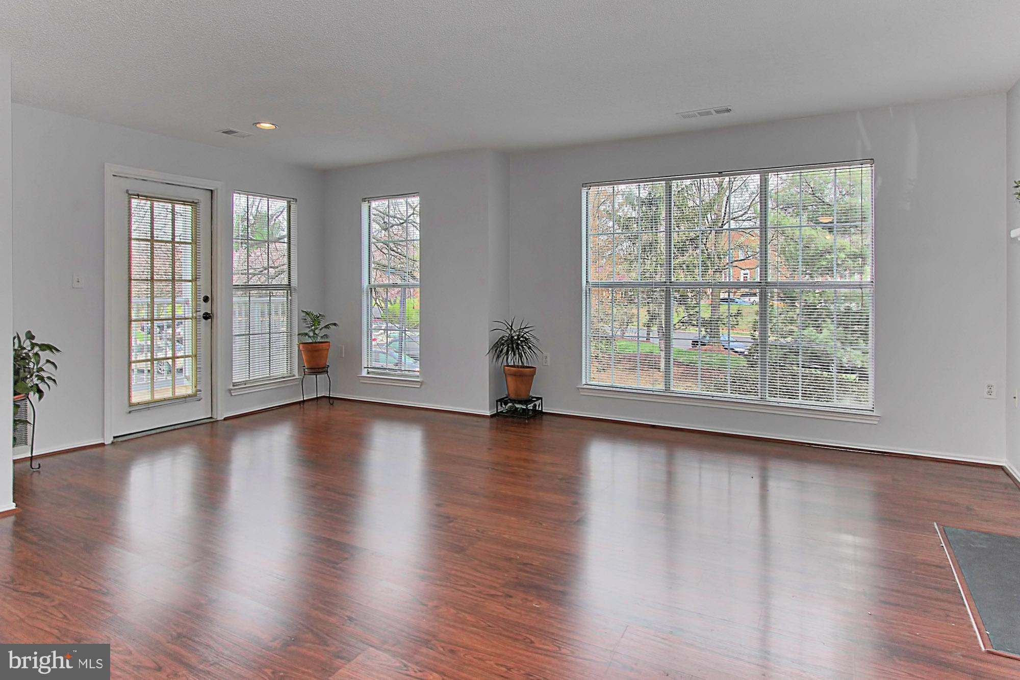 20950 Timber Ridge Terrace, Unit 201 Ashburn, VA 20147 - Photo 16 of 37 Bright living/dining area w/door to balcony/deck