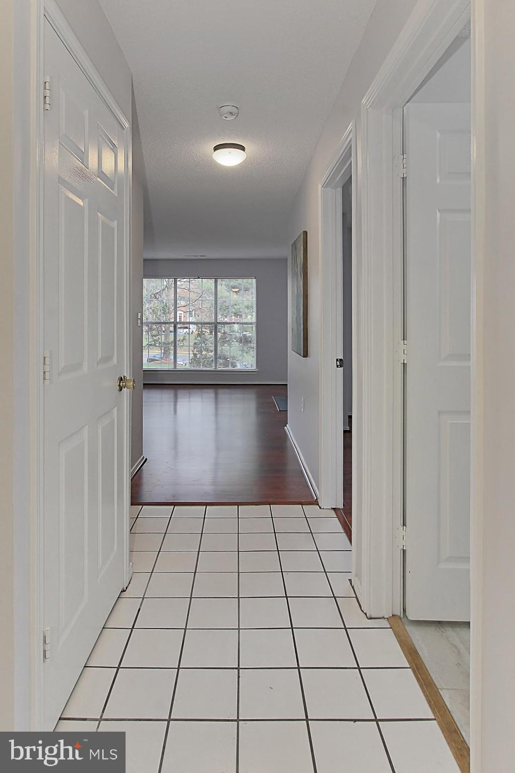 20950 Timber Ridge Terrace, Unit 201 Ashburn, VA 20147 - Photo 4 of 37 Foyer with coat closet and laundry closet