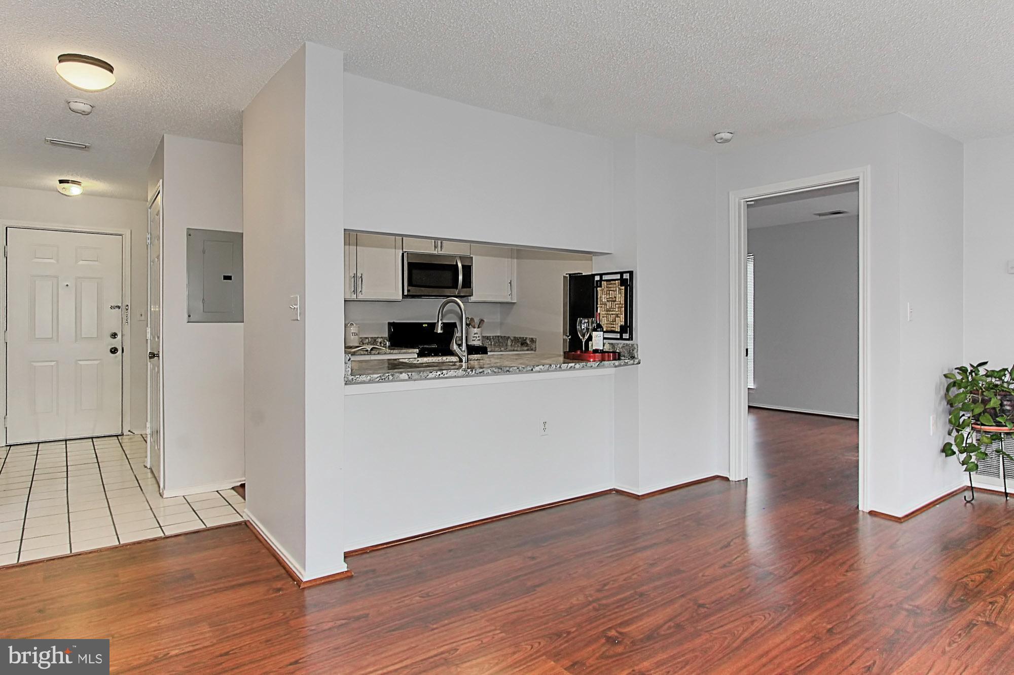 20950 Timber Ridge Terrace, Unit 201 Ashburn, VA 20147 - Photo 5 of 37 Kitchen w/ breakfast bar w/space for bar stools