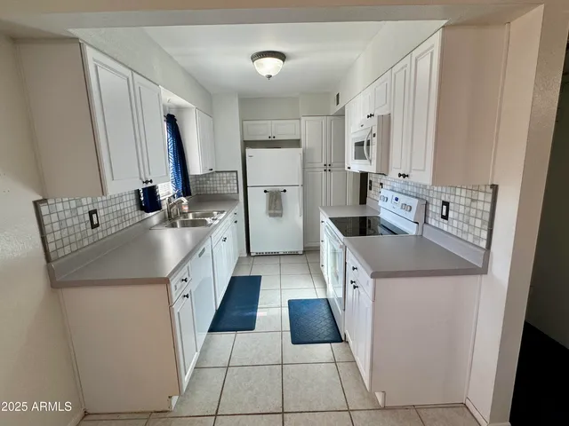 a kitchen with stainless steel appliances a sink stove and refrigerator