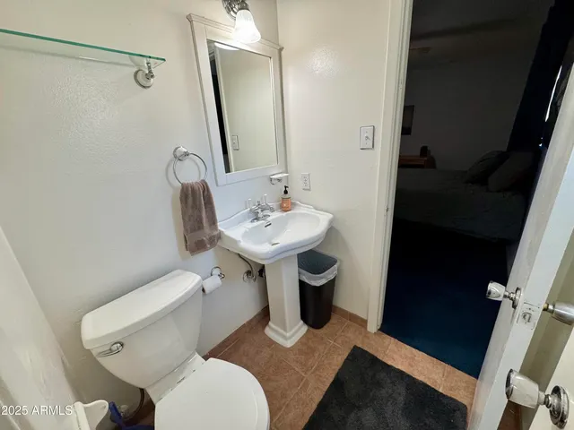 a white toilet sitting next to a bathroom sink