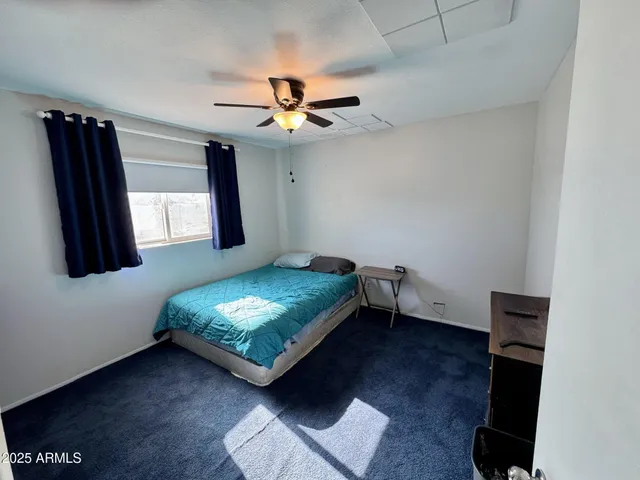 a bedroom with furniture and a window