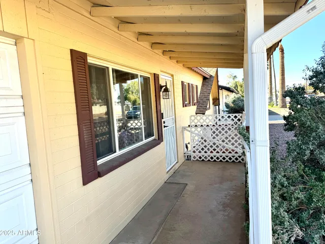 a view of a porch with a table and chairs