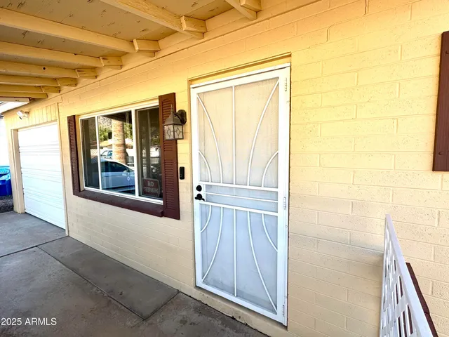 a view of a porch with a table and chairs