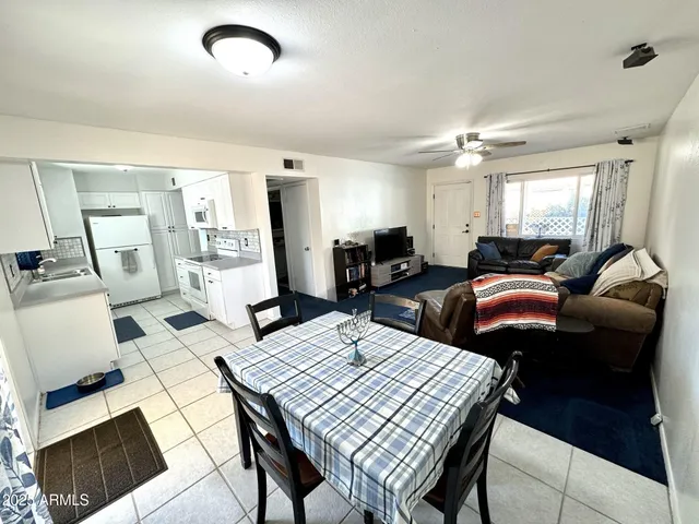 a living room with lots of furniture and wooden floor