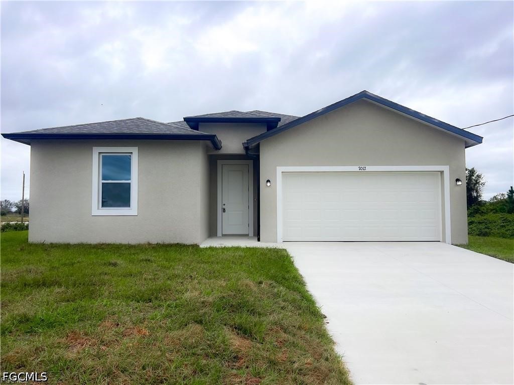 7012 Jolly Circle LaBelle, FL 33935 - Photo 1 of 12 a view of backyard of house with garage