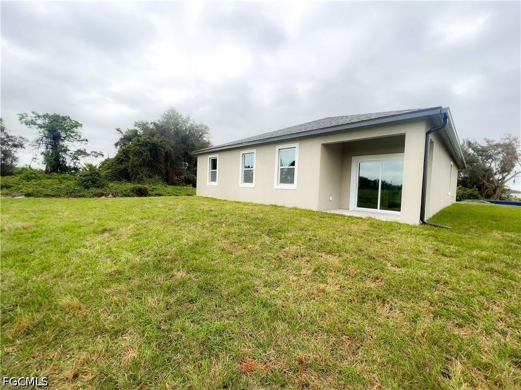 7012 Jolly Circle LaBelle, FL 33935 - Photo 12 of 12 a house with garden in front of it
