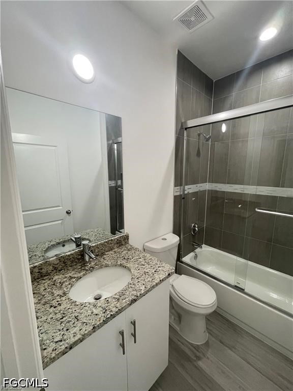 7012 Jolly Circle LaBelle, FL 33935 - Photo 5 of 12 a bathroom with a granite countertop sink toilet and shower