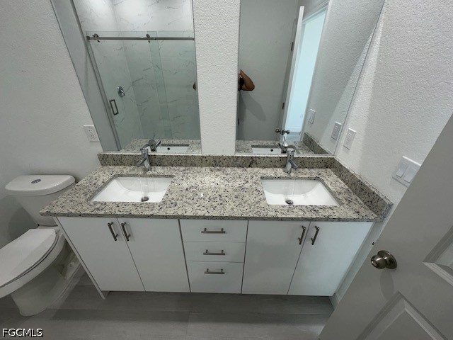 7012 Jolly Circle LaBelle, FL 33935 - Photo 6 of 12 a bathroom with a granite countertop sink and a mirror