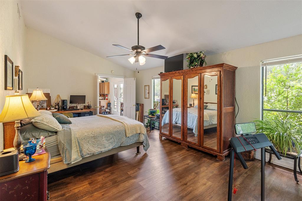 713 Midway Road Tool, TX 75143 - Photo 18 of 28 a bedroom with bed and wooden floor