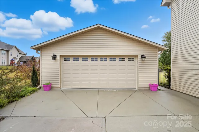 a view of a pathway of a house with potted plants and a pathway