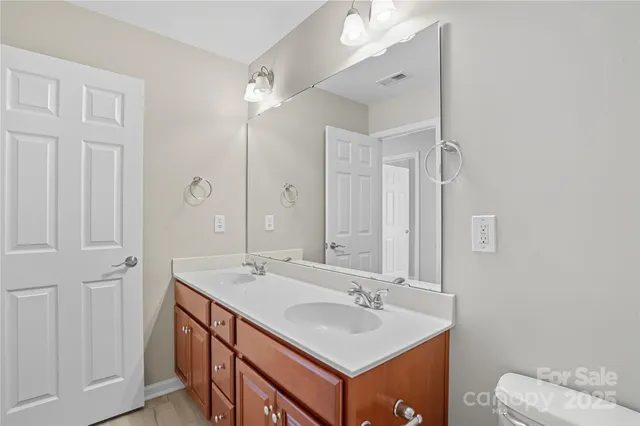 an empty room with a fan and a window