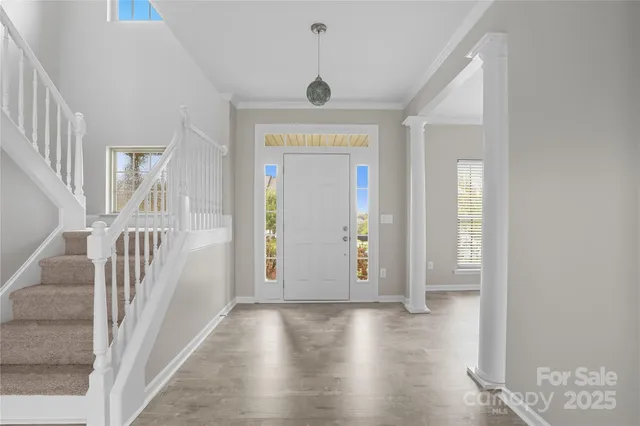 a view of an empty room with a fireplace and a window