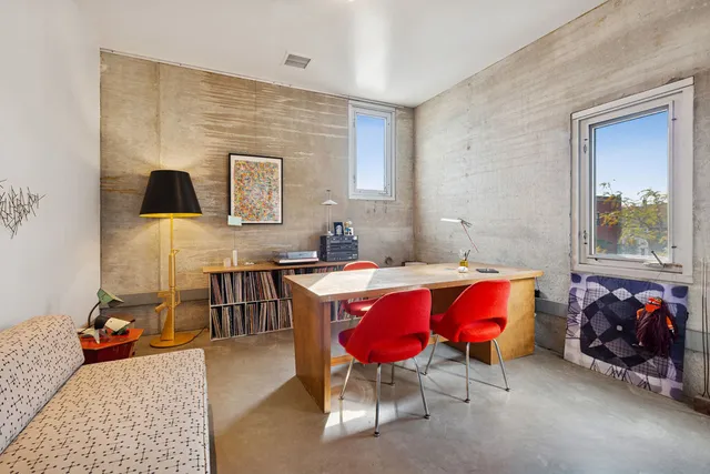a living room with furniture and book shelf