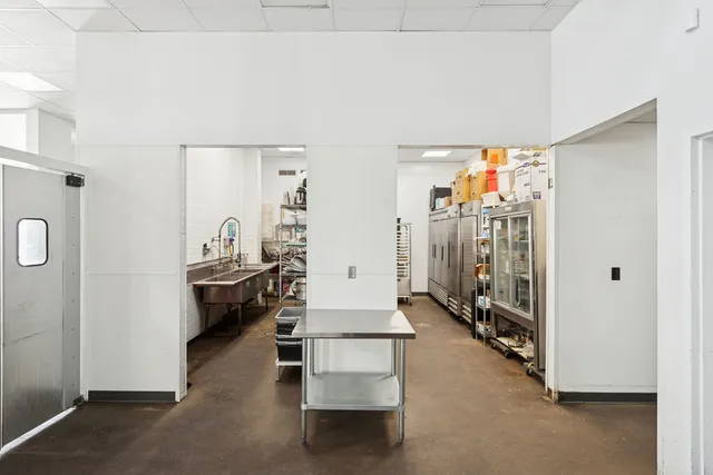 a view of a kitchen with a sink and cabinets