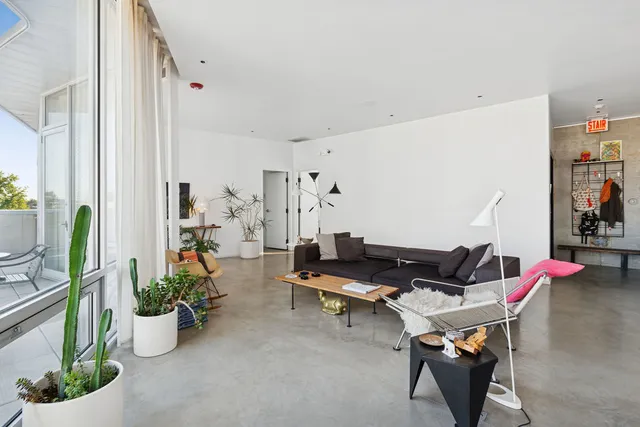 a living room with furniture and flowers
