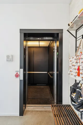 a living room with stainless steel appliances kitchen island granite countertop furniture and a flat screen tv