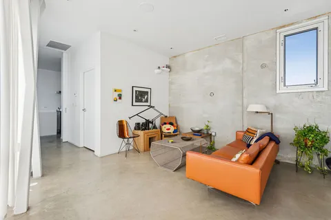 a living room with furniture and a floor to ceiling window