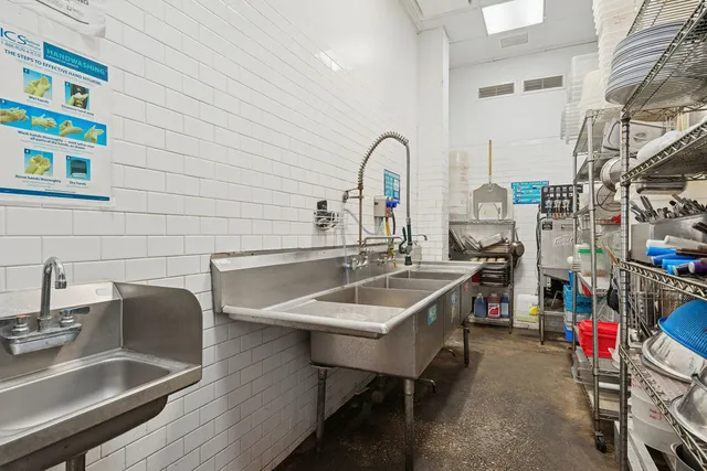 a view of a kitchen with a sink and cabinets