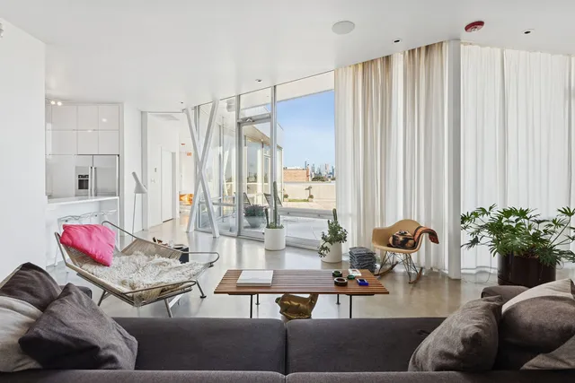 a living room with furniture and flowers